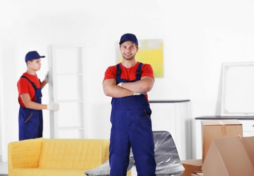 Removal team handling furniture in a Bermondsey flat move