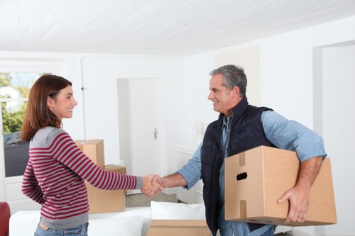 Mover wearing PPE while carrying furniture safely