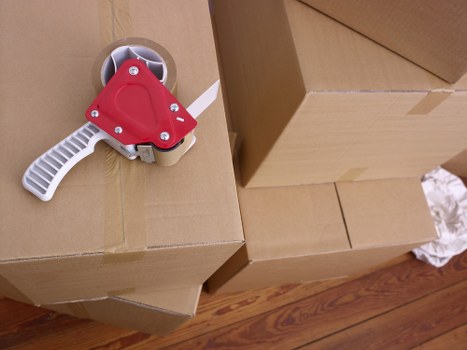 Local movers handling furniture outside a Bermondsey property